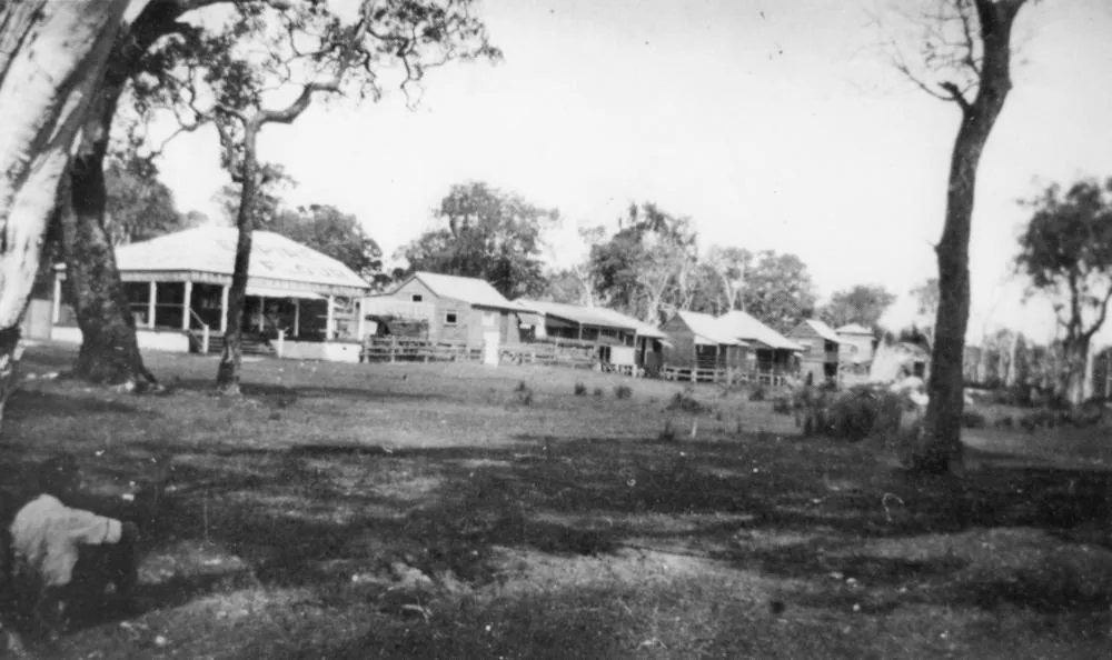 Fishing shacks on the foreshore at Cribb Island, 1926 Six wooden shacks above the high water mark at the beach on Cribb Island face the sea. An upturned rowing boat is pulled up on the sand.