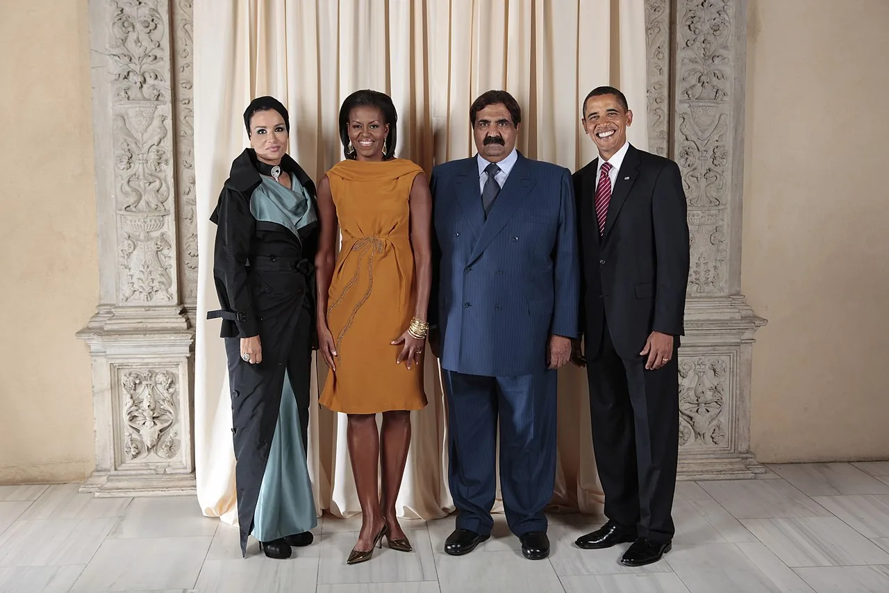 President Barack Obama and First Lady Michelle Obama pose for a photo during a reception at the Metropolitan Museum in New York with Hamad Bin Khalifa Al-Thani and his second wife, Sheikha Mozah bint Nasser Al Missned.