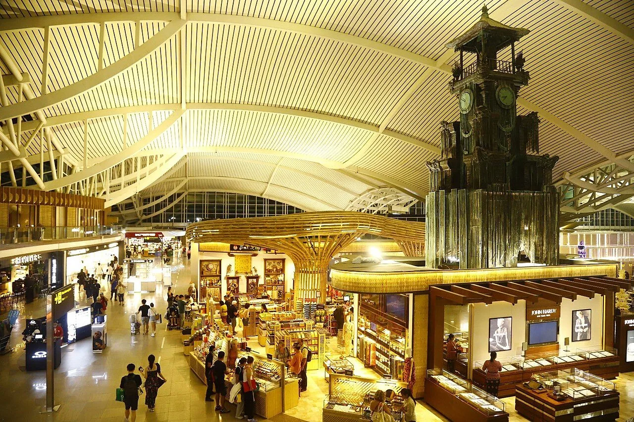 View of the restaurants and shops at the airside of Ngurah Rai Airport International Terminal. The well known clock tower is also visible.