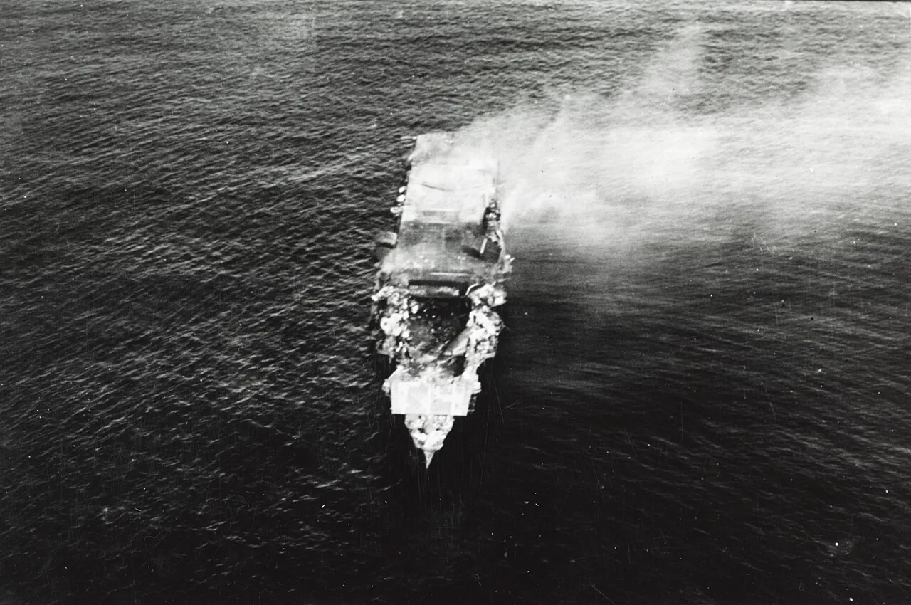 The burning Japanese aircraft carrier Hiryu , photographed by a Yokosuka B4Y aircraft from the carrier Hosho shortly after sunrise on 5 June 1942. Hiryu sank a few hours later. Flight deck torn out by the bomb dropped du