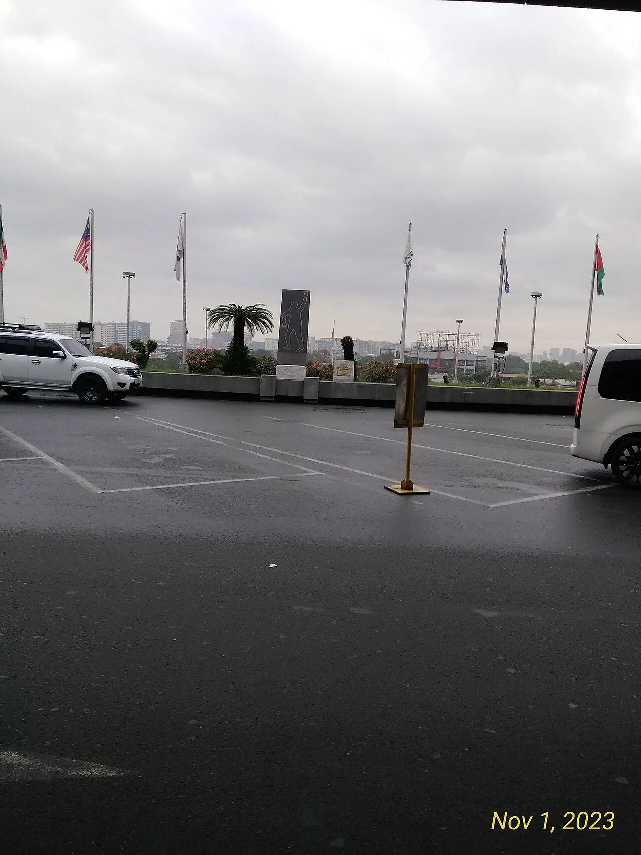 Tall black stone w:Assassination of Ninoy Aquino monument on upper level of same named airport.