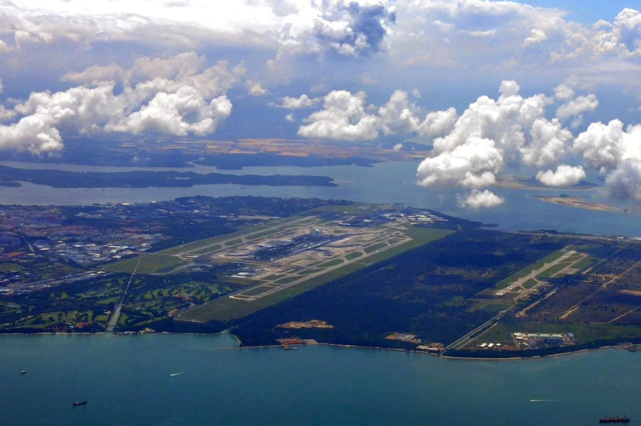 Aerial view of Singapore Changi Airport and runways (centre) , with Changi Air Base (East) and its single runway on the right.