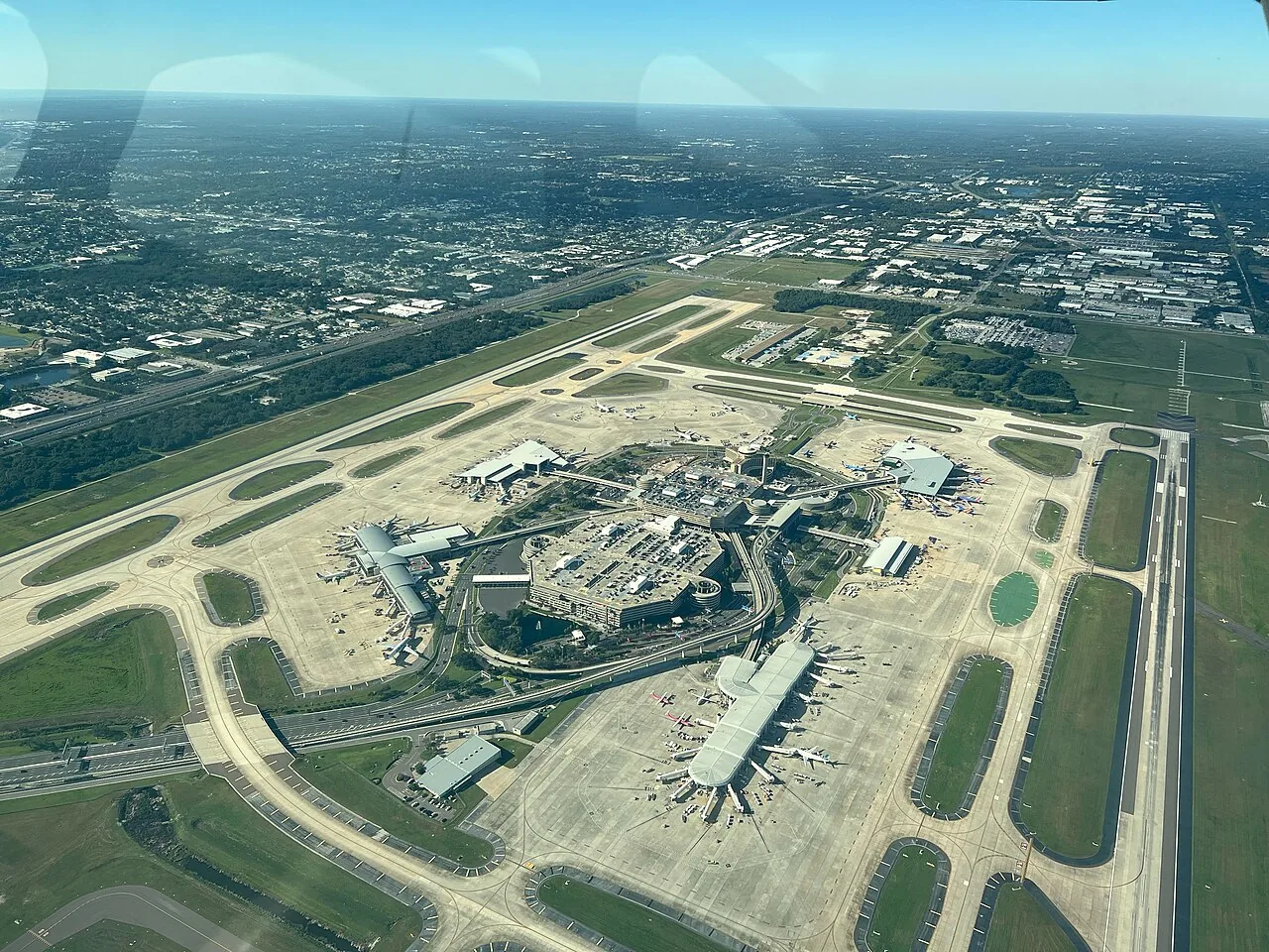Photo taken from approximately 2100 feet over RWY 10/28 while on the bridge transition to the east. This photo is taken from the southeast corner of the airfield and looks northwest. Airside A (bottom right), Airside C (