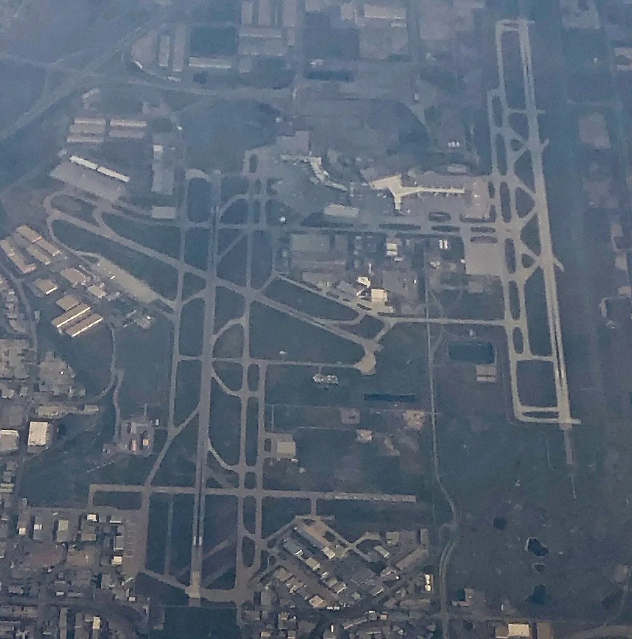 View of Calgary International Airport while flying past on a cross-country trip, north toward top of image, taken with iPhone8 on 8 Sept 2021. Touched up somewhat due to glare on morning haze.